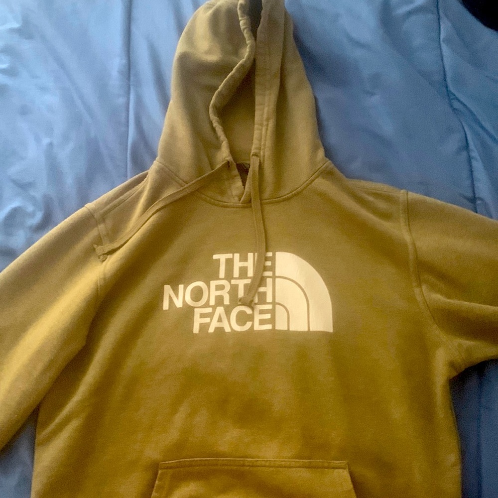 The North Face olive green hoodie is in good condition